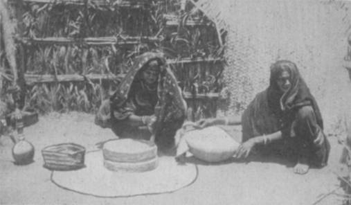 WOMEN GRINDING AT THE MILL.